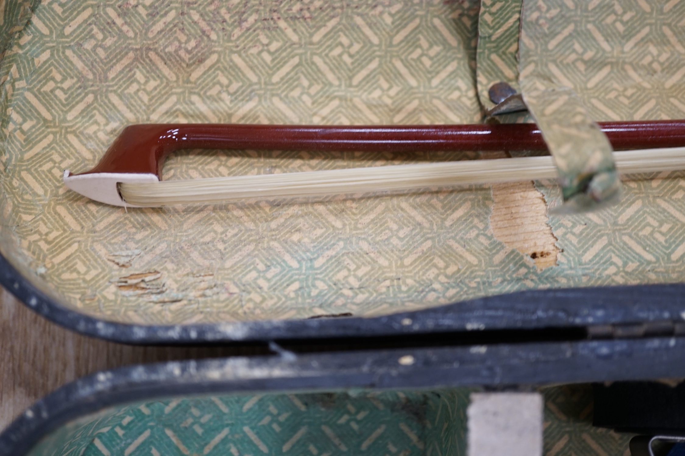 A mid 19th century cased French violin, length of body 35.5cm, with bow, simulated ivory tip